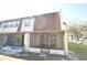 Exterior view of the townhome with covered porch, showing the facade and lawn area at 6043 Topher Trl # 6043, Mulberry, FL 33860