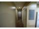 Hallway with neutral walls and wood-look floors; a functional space connecting the living area to the rest of the condo at 6055 Topher Trl # 6055, Mulberry, FL 33860