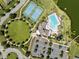 Aerial view of resort-style community amenities including swimming pool, tennis courts, and green spaces at 6249 Great Bear Dr, Lakeland, FL 33805