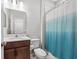 Bathroom with modern vanity, toilet, and blue-and-white shower curtain at 6249 Great Bear Dr, Lakeland, FL 33805