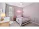 Charming bedroom featuring a neon name sign, soft pink accents, and plush carpeting at 6249 Great Bear Dr, Lakeland, FL 33805