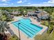 A stunning resort-style pool and clubhouse featuring lounge chairs, palm trees and pristine landscaping at 6249 Great Bear Dr, Lakeland, FL 33805