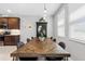 Dining area features a stylish wood table, modern lighting, and view of the kitchen at 6249 Great Bear Dr, Lakeland, FL 33805