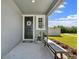 Inviting front porch with a decorative wreath on the front door and bench seating at 6249 Great Bear Dr, Lakeland, FL 33805