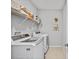 Functional laundry room featuring a washer, dryer, storage shelf, and décor at 6249 Great Bear Dr, Lakeland, FL 33805