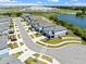 A lovely street view of modern homes next to a pond with an industrial building in the background at 6249 Great Bear Dr, Lakeland, FL 33805