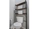 Bathroom featuring a toilet with overhead storage and a stylish toilet paper holder at 6249 Great Bear Dr, Lakeland, FL 33805