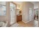 Neutral bathroom featuring tile floors, a soaking tub, walk in shower and wood cabinets at 6339 Alamanda Hills Dr, Lakeland, FL 33813