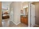 Ensuite bathroom with a dark wood vanity, sink and tile floors at 6339 Alamanda Hills Dr, Lakeland, FL 33813