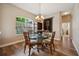 Elegant dining room with a glass table, stylish chairs, and a view of the living areas at 6339 Alamanda Hills Dr, Lakeland, FL 33813