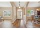 Elegant foyer with wood floors, arched doorways, and a view of the formal dining area at 6339 Alamanda Hills Dr, Lakeland, FL 33813