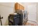 Laundry area with a washer, dryer and storage cabinets at 6339 Alamanda Hills Dr, Lakeland, FL 33813