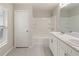 The bright bathroom has a double sink vanity, a window, and a shower over tub at 645 Sarner Pass Way, Winter Haven, FL 33881