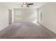 The bedroom is a good size with two windows and neutral carpet and wall paint at 645 Sarner Pass Way, Winter Haven, FL 33881