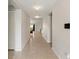 Long hallway with neutral walls and tile floors leading to the living areas at 645 Sarner Pass Way, Winter Haven, FL 33881