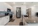 Kitchen featuring a granite island, stainless steel refrigerator, and ample cabinet space at 645 Sarner Pass Way, Winter Haven, FL 33881