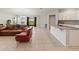 Open-concept living area with tile flooring seamlessly connecting the living room and kitchen at 645 Sarner Pass Way, Winter Haven, FL 33881