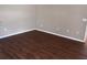 A cozy bedroom with neutral color walls and wood-look flooring at 6528 Shepherd Oaks Pass, Lakeland, FL 33811