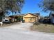 Charming single-story home featuring an attached two-car garage and well-maintained lawn and garden at 6528 Shepherd Oaks Pass, Lakeland, FL 33811