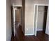 Hallway with wood floors and two bedrooms with closets at 6528 Shepherd Oaks Pass, Lakeland, FL 33811