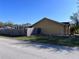 A view of the side yard with a wooden fence, lush lawn, and a glimpse of a neighboring home at 6528 Shepherd Oaks Pass, Lakeland, FL 33811