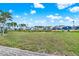 Expansive backyard with lush green grass and views of neighboring homes at 6792 Brentwood Ne Dr, Winter Haven, FL 33881