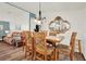 Dining area with wooden furniture and a view into the living room and kitchen at 6792 Brentwood Ne Dr, Winter Haven, FL 33881