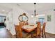 Dining area with a wooden table, six chairs, and a decorative ornate mirror at 6792 Brentwood Ne Dr, Winter Haven, FL 33881