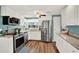 Bright kitchen featuring stainless steel appliances, white cabinets, and granite countertops at 6792 Brentwood Ne Dr, Winter Haven, FL 33881