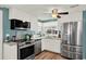 Updated kitchen featuring stainless steel appliances, white cabinets, and granite countertops at 6792 Brentwood Ne Dr, Winter Haven, FL 33881