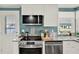 Well-lit kitchen featuring stainless steel appliances and granite countertops at 6792 Brentwood Ne Dr, Winter Haven, FL 33881