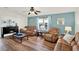 Bright living room featuring laminate floors, cozy furniture, and natural light at 6792 Brentwood Ne Dr, Winter Haven, FL 33881