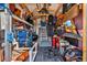 Interior view of shed featuring ladders, storage containers, and various household items on shelves at 6792 Brentwood Ne Dr, Winter Haven, FL 33881