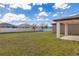 Large backyard with lush green grass and a white fence offering privacy at 685 Meadow Pointe Dr, Haines City, FL 33844