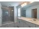 Elegant bathroom featuring a glass-enclosed shower, dual sink vanity with ample counter space, and modern fixtures at 685 Meadow Pointe Dr, Haines City, FL 33844