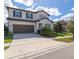 Two-story home with a two-car garage, dark shutters, and a manicured lawn at 685 Meadow Pointe Dr, Haines City, FL 33844