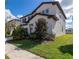 Side view of a two-story home with dark shutters and mature landscaping at 685 Meadow Pointe Dr, Haines City, FL 33844