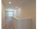 Bright hallway with neutral walls, plush carpet, and ample lighting creating a welcoming atmosphere at 685 Meadow Pointe Dr, Haines City, FL 33844