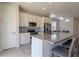 Bright, open kitchen with modern island, stainless appliances, and white cabinetry at 685 Meadow Pointe Dr, Haines City, FL 33844