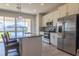 Open kitchen with stainless steel appliances, island, and views of backyard at 685 Meadow Pointe Dr, Haines City, FL 33844