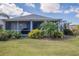 This lovely home offers a screened in lanai, lush tropical plants and privacy at 7104 Lake Eaglebrooke Way, Lakeland, FL 33813