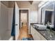 Bathroom featuring a granite-topped vanity, modern sink, and a tub-shower combo at 7104 Lake Eaglebrooke Way, Lakeland, FL 33813