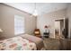 Bedroom features ceiling fan, neutral paint and carpet, with easy access to the en-suite bathroom at 7104 Lake Eaglebrooke Way, Lakeland, FL 33813