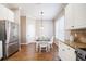 Light-filled dining area with wood-look tile floors, pendant lighting, and access to the kitchen at 7104 Lake Eaglebrooke Way, Lakeland, FL 33813