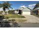 Charming single-story home featuring a well-manicured lawn, mature landscaping and a two-car garage at 7104 Lake Eaglebrooke Way, Lakeland, FL 33813