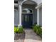 Inviting front entrance featuring a decorative glass door, sidelights and a brick walkway at 7104 Lake Eaglebrooke Way, Lakeland, FL 33813