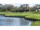 Scenic view of the community golf course, with lush green fairways next to a lake at 7104 Lake Eaglebrooke Way, Lakeland, FL 33813