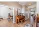 Hallway with light-colored walls, wood floors, and view of the office at 7104 Lake Eaglebrooke Way, Lakeland, FL 33813