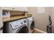 Laundry room with modern washer and dryer, complemented by granite countertops at 7104 Lake Eaglebrooke Way, Lakeland, FL 33813