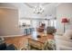 Cozy living room with wood floors, chandelier and an open layout with the kitchen at 7104 Lake Eaglebrooke Way, Lakeland, FL 33813